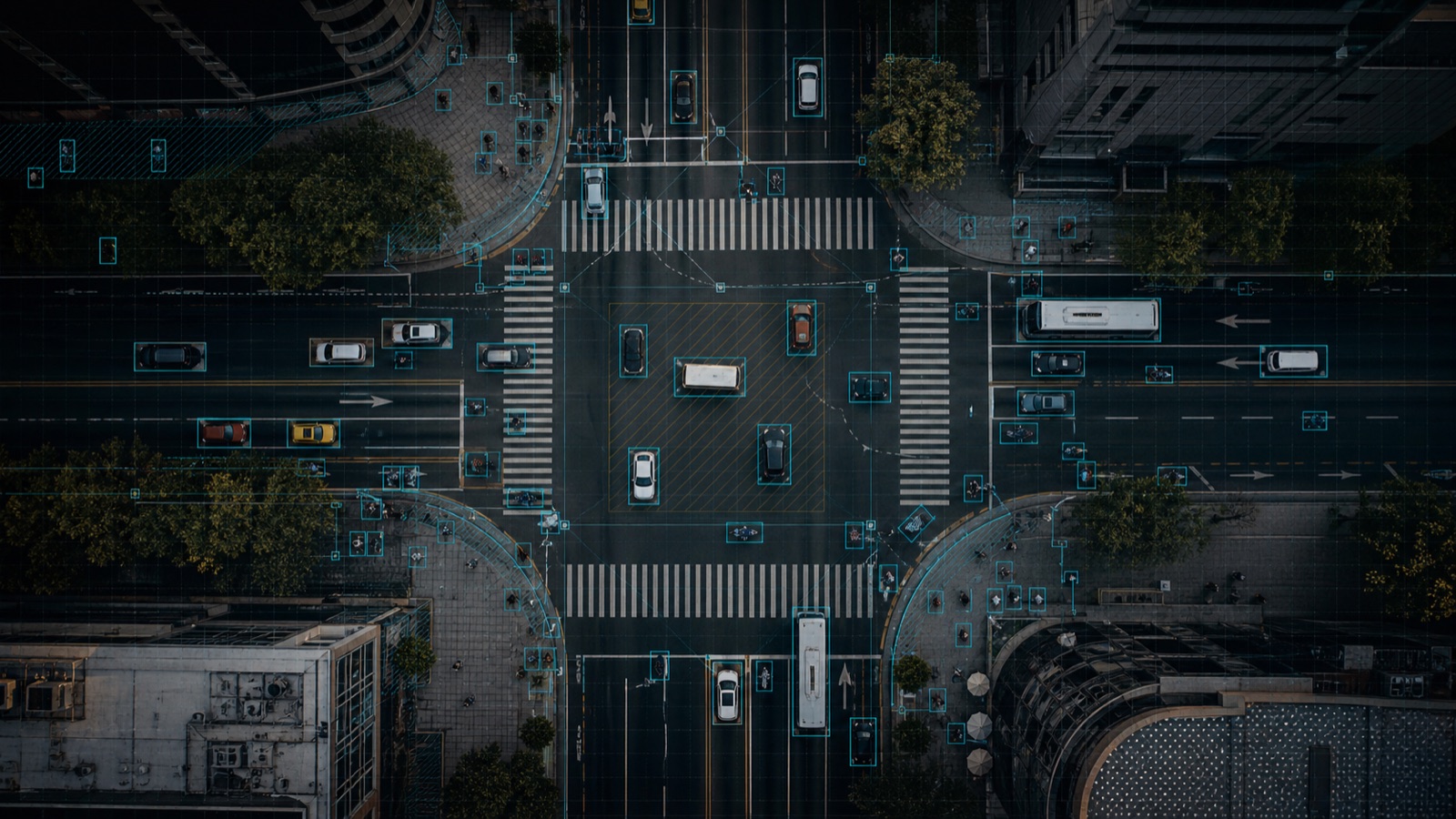 Aerial view of a dense intersection with small vehicles and pedestrians marked by precise annotation boxes